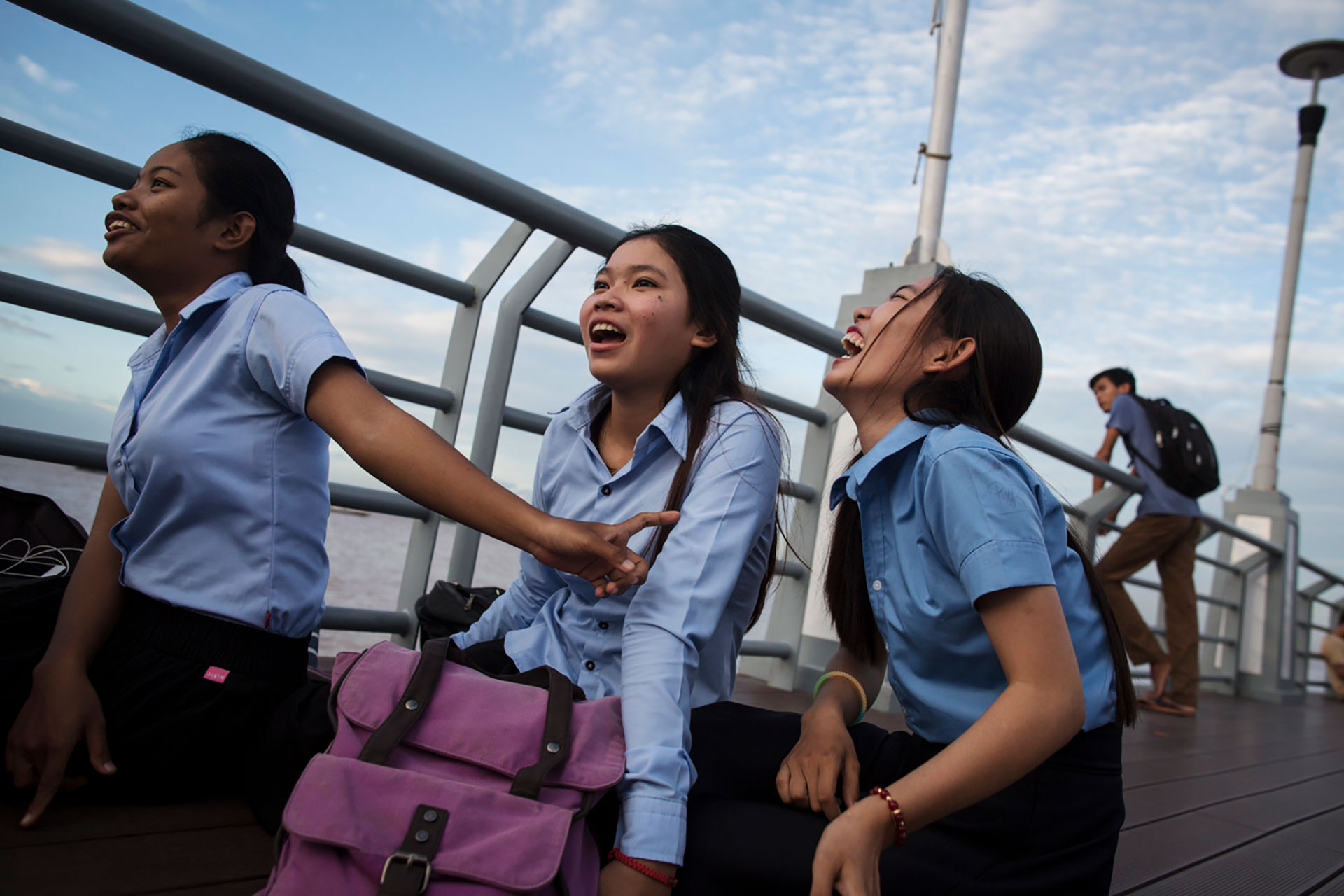 Midwife students hangout on the boardwalk, in Phnom Penh, Cambodia, July 27, 2017. All of these students, who are in their first year of midwifery school didn't know that abortion was legal except in special cases. None of them had boyfriends at the moment, but some had in the past. One had broken up with a boy because he cheated on her, and another because she 'needed to be free'. Cambodia has a very traditional culture, which makes it hard for young women to meet friends or boys outside the home, particularly in rural areas. But in the cities, urban teenage life is radically different from that of their country counterparts. Although still very conservative, and city girls are subject to strict curfews, they also can spend their free time with friends prowling through malls and sitting on boardwalks, eating out, or skateboarding. 