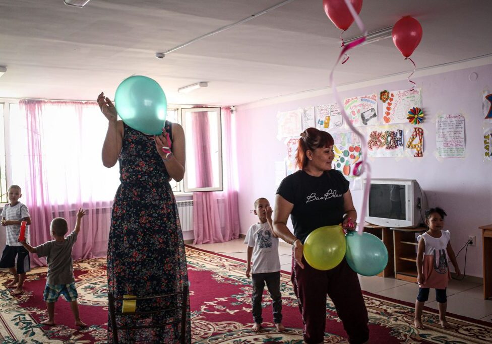 Teachers and helpers set up for a child's quiz in the playroom of a rehabilitation center for former ISIS wives, in Aktau, Kazakstan, Monday July 22, 2019. The Kazakh government converted an old day camp into a "rehabilitation center". There, the women, who usually come with their children, get treatment from psychologists and moderate Muslim imams intended to cure their radicalism and re-integrate them into society.