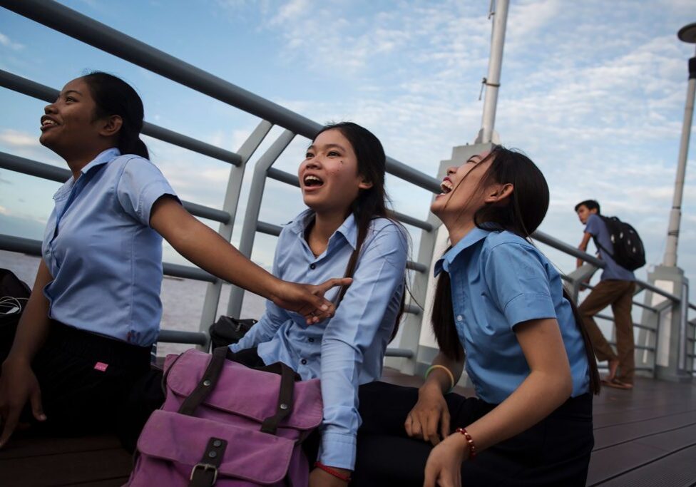 Midwife students hangout on the boardwalk, in Phnom Penh, Cambodia, July 27, 2017. All of these students, who are in their first year of midwifery school didn't know that abortion was legal except in special cases. None of them had boyfriends at the moment, but some had in the past. One had broken up with a boy because he cheated on her, and another because she 'needed to be free'. Cambodia has a very traditional culture, which makes it hard for young women to meet friends or boys outside the home, particularly in rural areas. But in the cities, urban teenage life is radically different from that of their country counterparts. Although still very conservative, and city girls are subject to strict curfews, they also can spend their free time with friends prowling through malls and sitting on boardwalks, eating out, or skateboarding. 