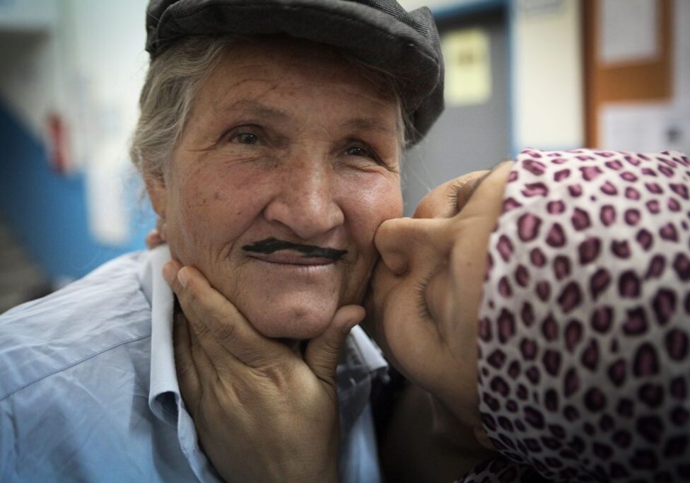 Cennet Sener, right, an actress in the Arslankoy Theater Group, playfully kisses another member of their troupe before their show, in a small village outside of Adana, southern Turkey.